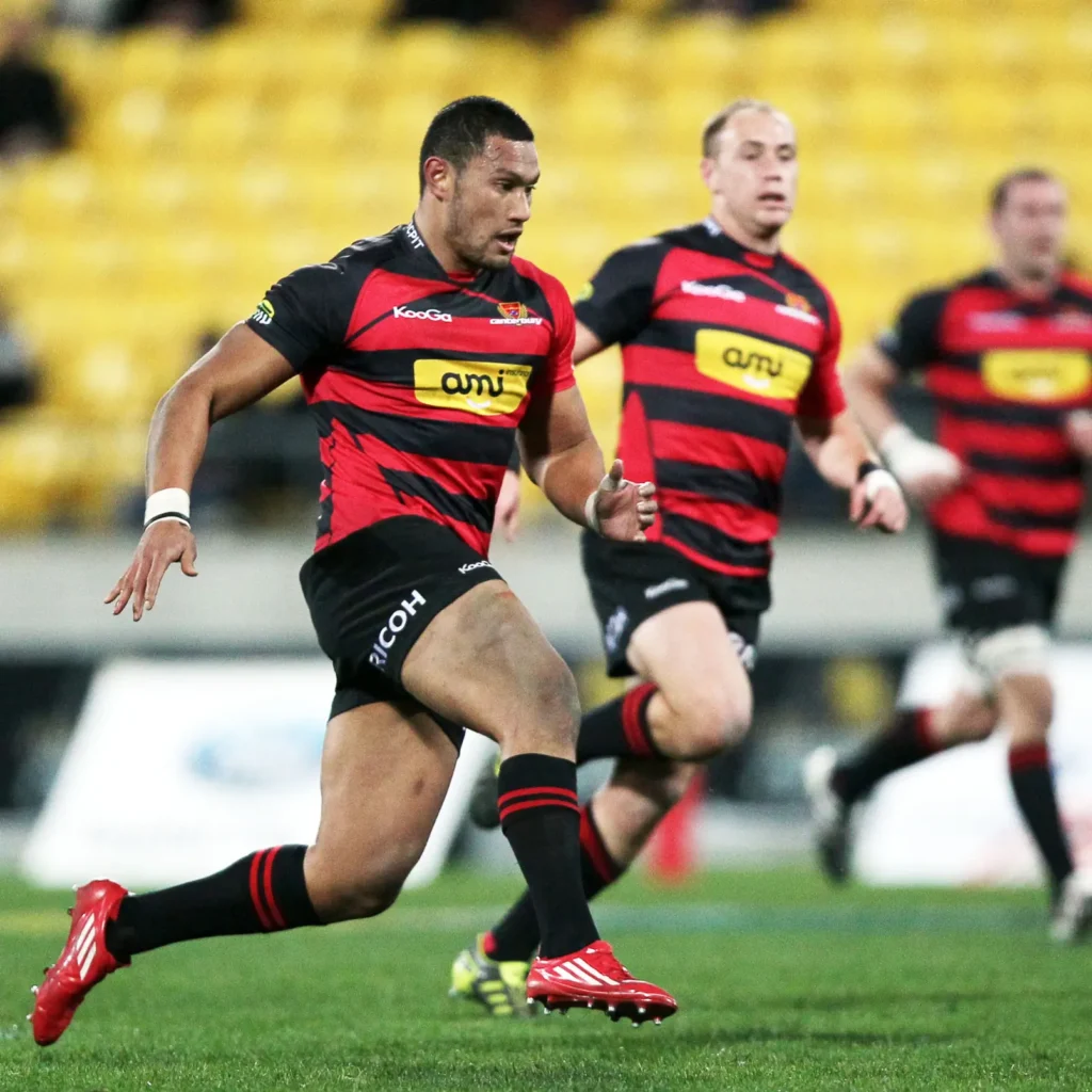 Rugby playrs wearing red black rugby uniforms